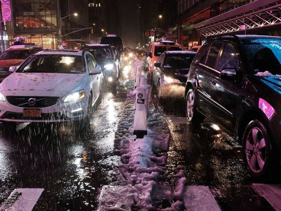 (Lead image: Cars pause in traffic in Manhattan during Thursday's snowfall. Photo by Spencer Platt/Getty Images)